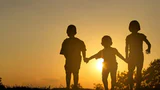 Happy,Children,Jumping,On,Sunset,Background